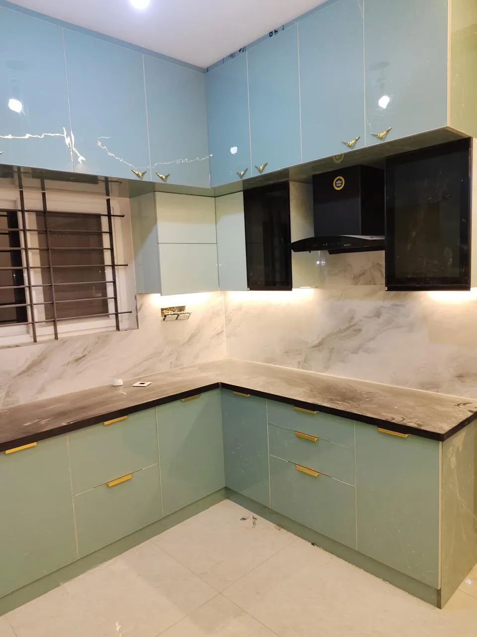 The same modular kitchen completed with lighting and appliances